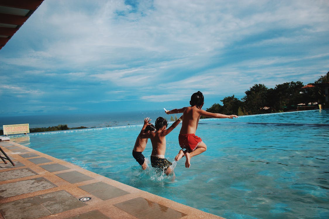 Smiling family enjoying their clean swimming pool
